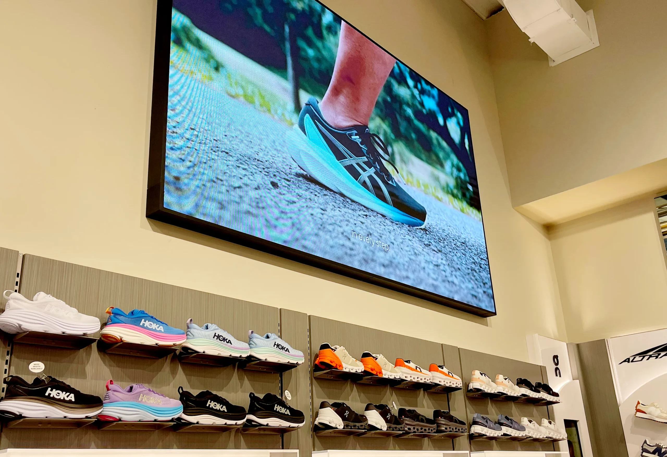 SCHEELS digital signage above a shoe display